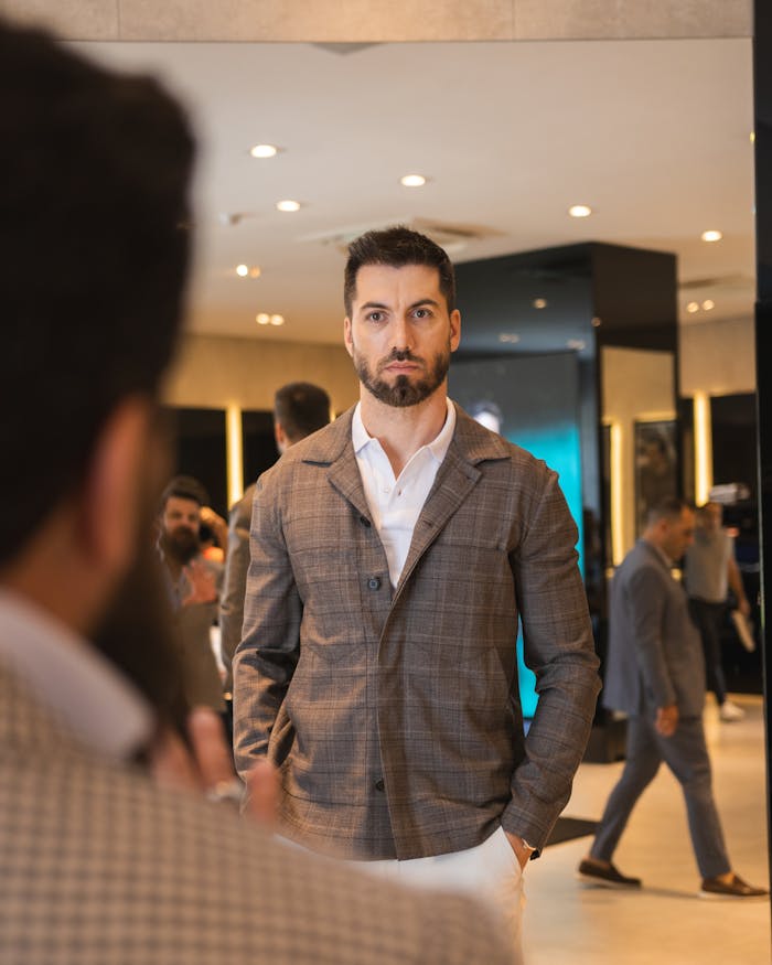 Home Well-dressed man in a fashionable store setting, showcasing modern elegance.